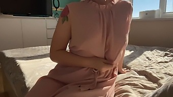 A Woman In A Feminine Pink Dress Explores Her Sensual Desires